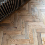 Worn Antique Oak Herringbone Engineered Wood Flooring with rich antique tones, and a classic herringbone pattern for a timeless, rustic look