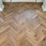 Worn Antique Oak Herringbone Engineered Wood Flooring with rich antique tones, and a classic herringbone pattern for a timeless, rustic look